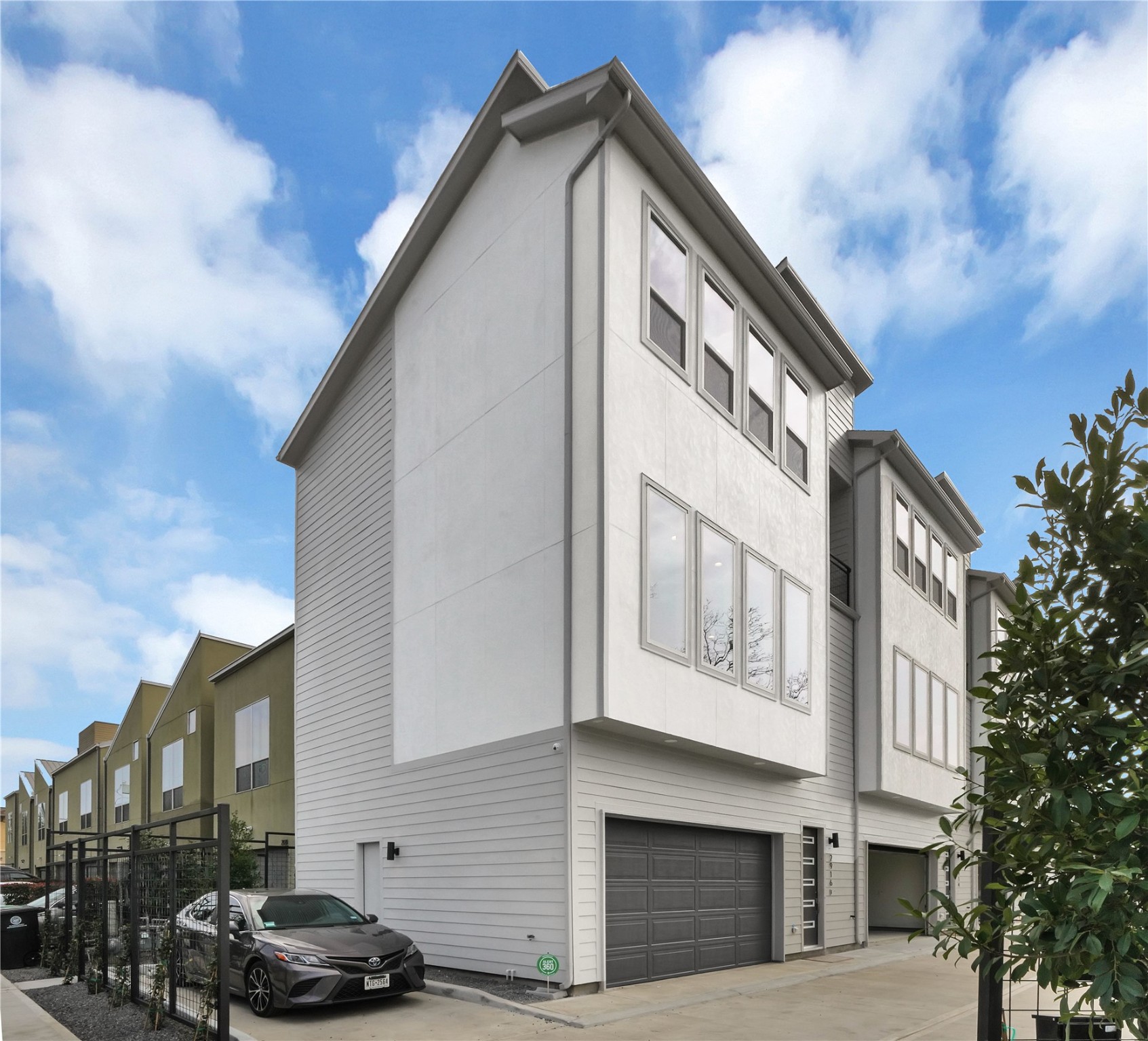 a front view of a building with lot of cars parked on road