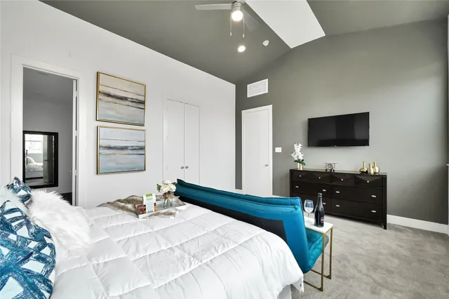 a bedroom with a bed and a flat screen tv