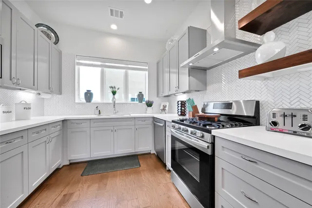 a kitchen with a stove oven and sink
