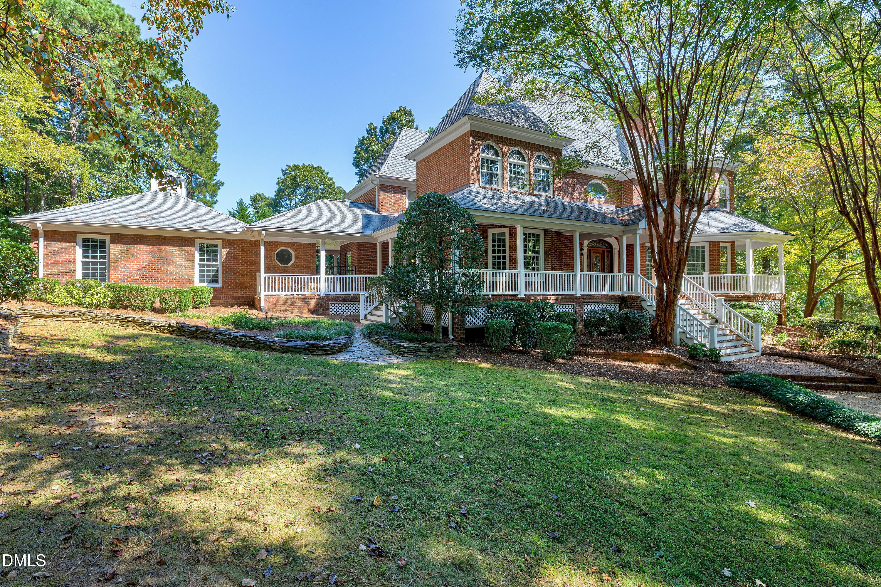 6825 Mactavish Way Raleigh, NC 27613 - Photo 2 of 100 a front view of a house with a yard and trees