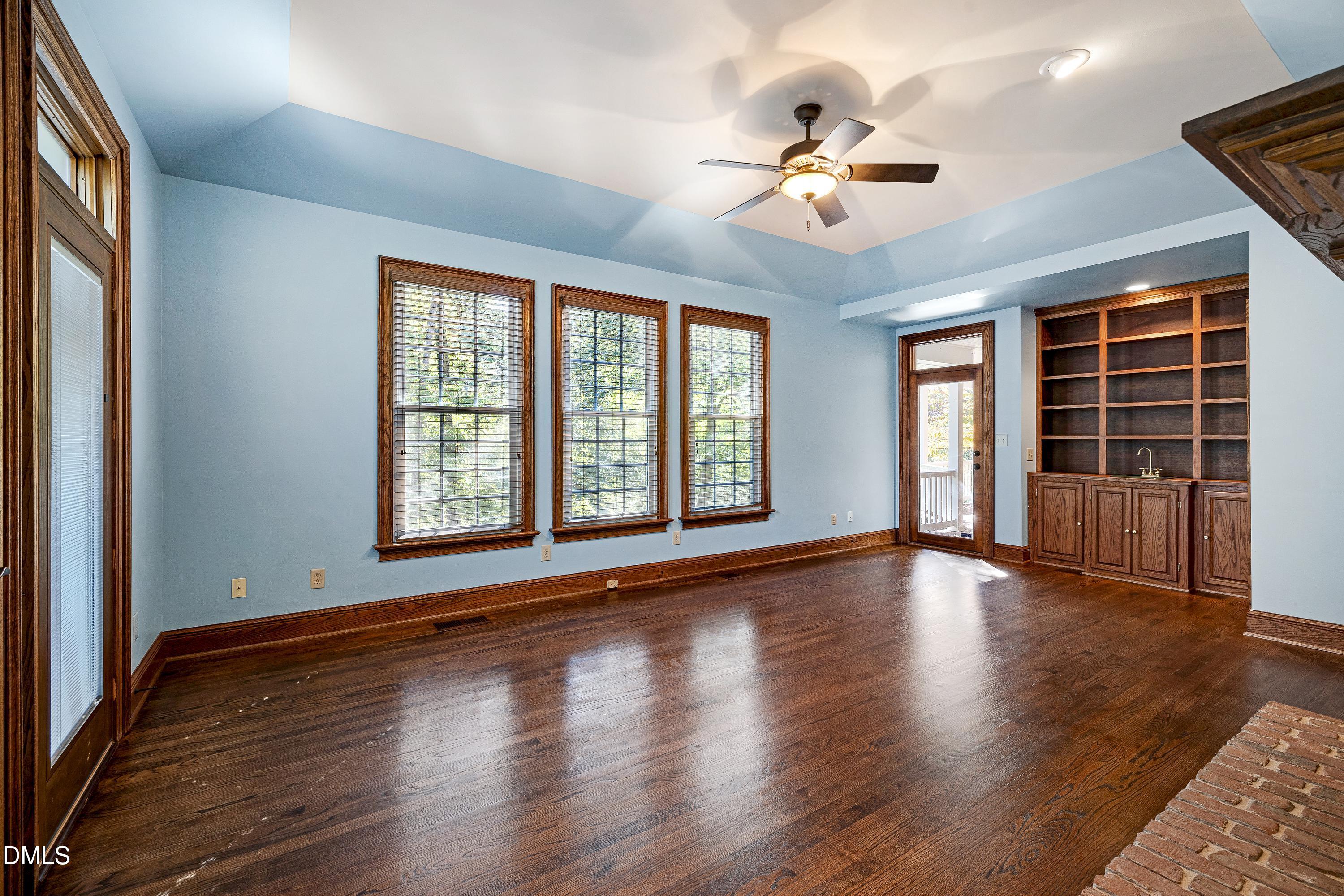 6825 Mactavish Way Raleigh, NC 27613 - Photo 22 of 100 a view of an empty room with wooden floor and a window