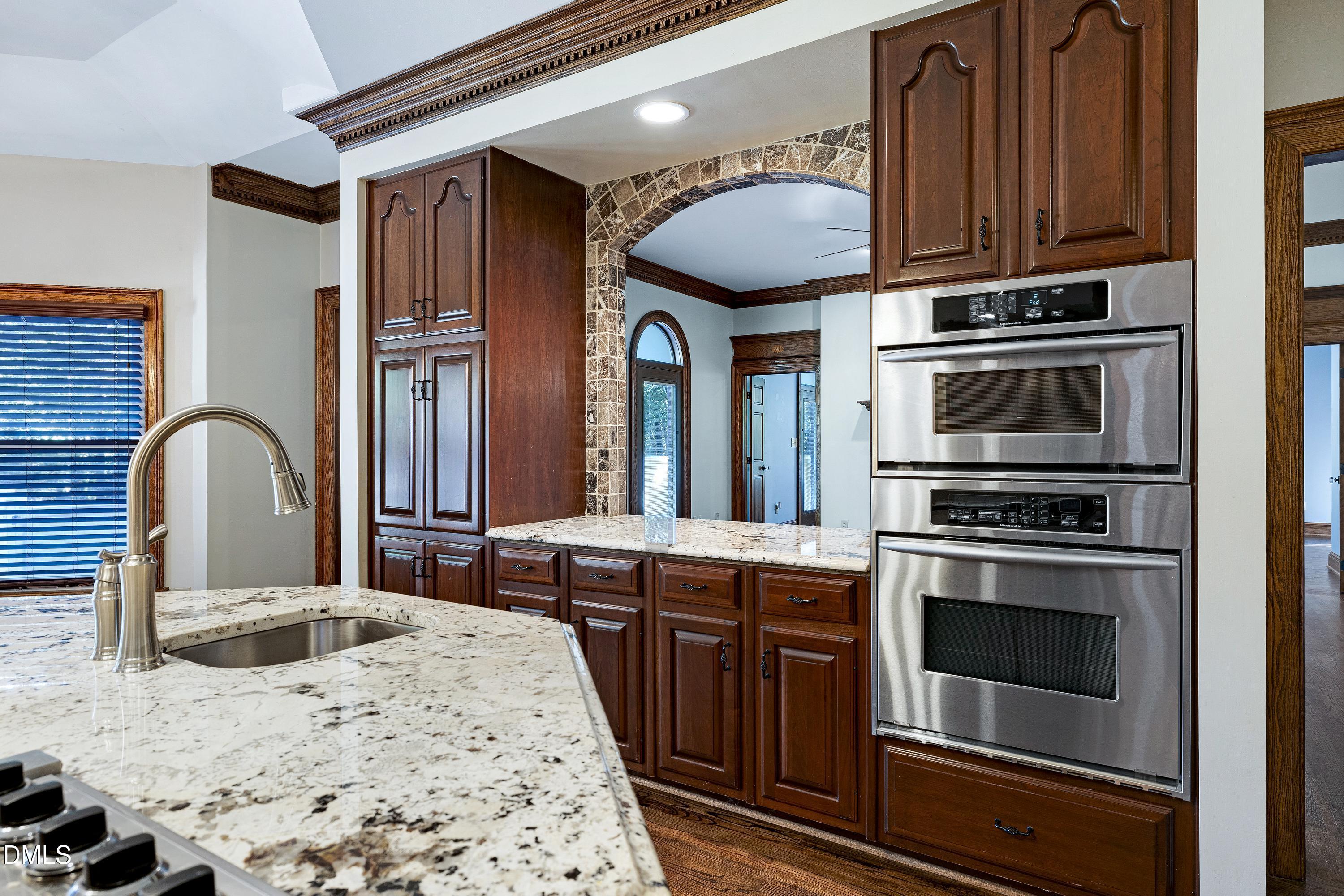 6825 Mactavish Way Raleigh, NC 27613 - Photo 29 of 100 a kitchen with stainless steel appliances granite countertop a stove a sink and a microwave
