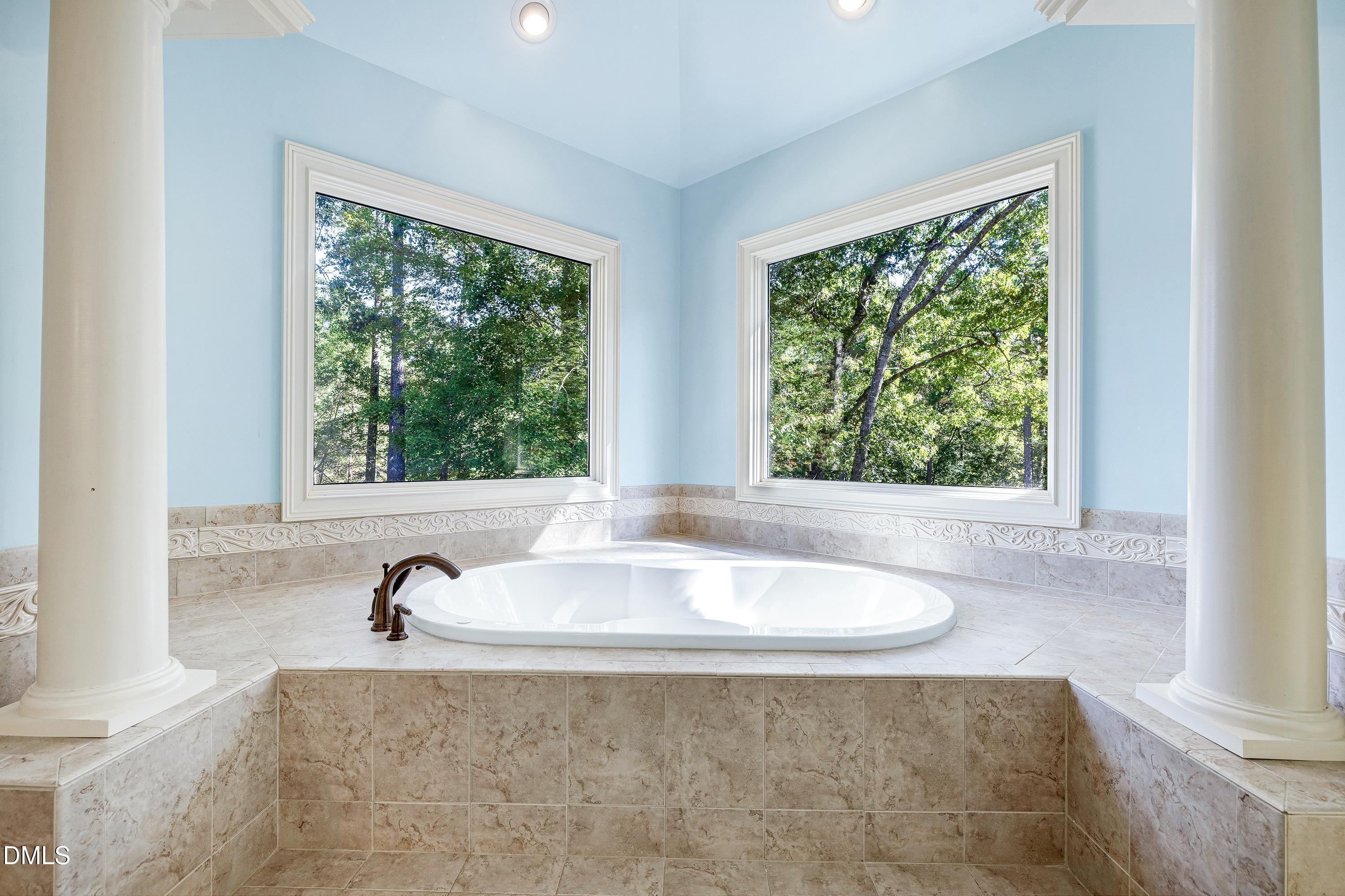 6825 Mactavish Way Raleigh, NC 27613 - Photo 36 of 100 a bath tub sitting in a bathroom next to a window