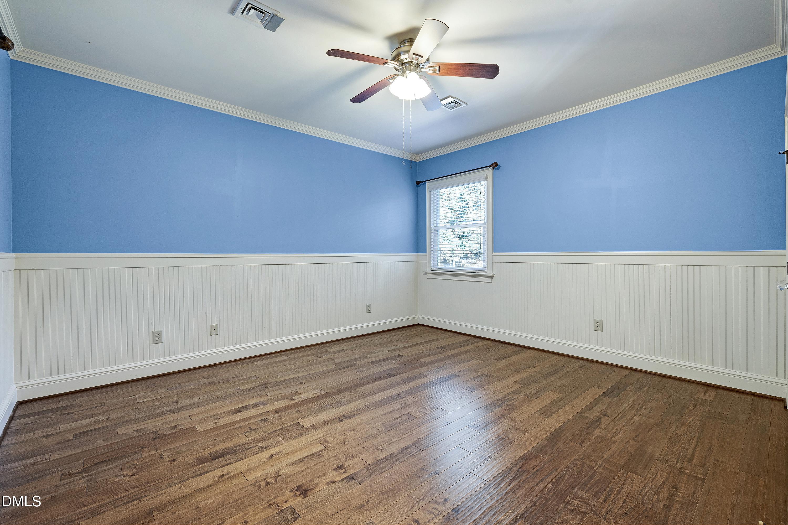 6825 Mactavish Way Raleigh, NC 27613 - Photo 40 of 100 an empty room with wooden floor and windows