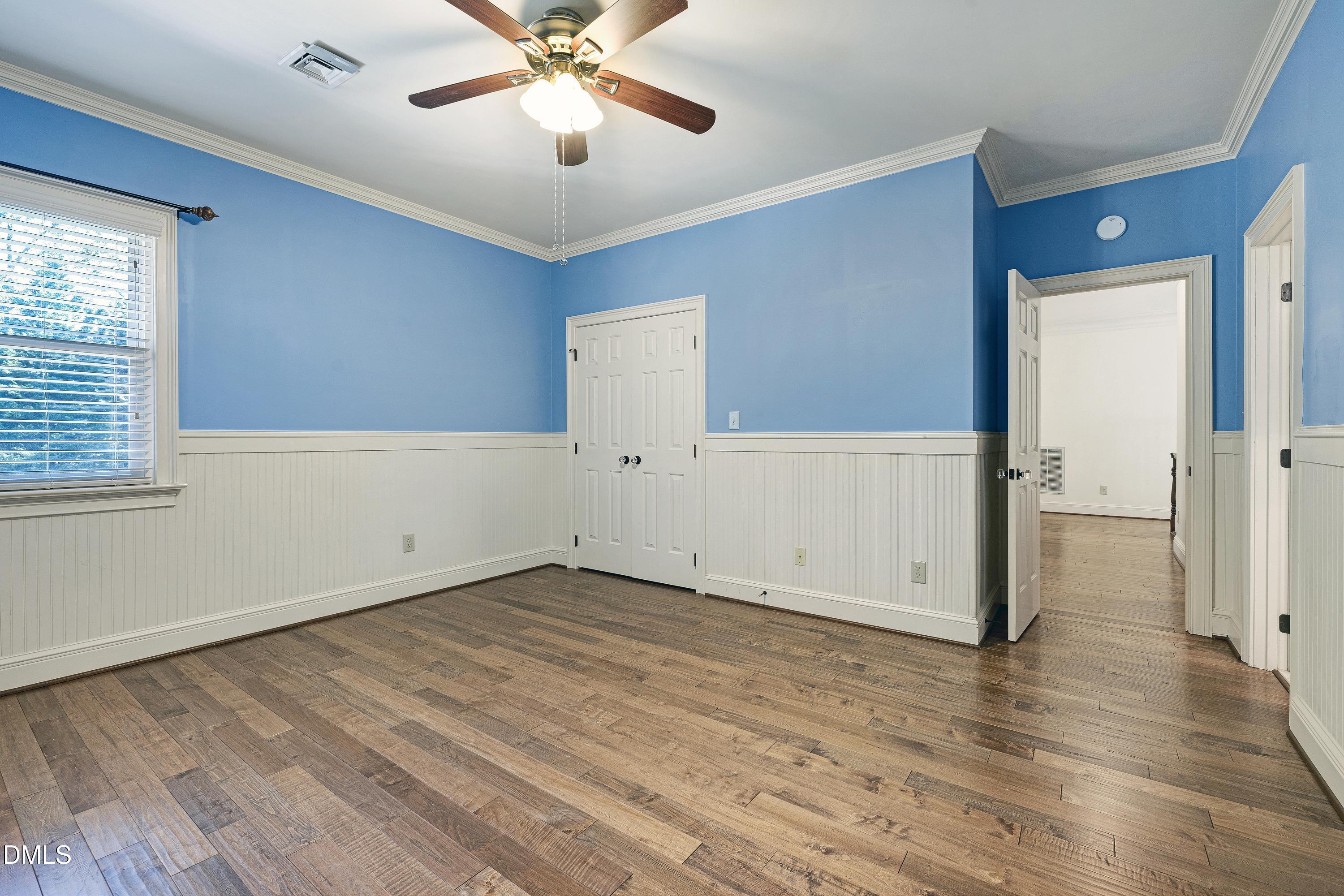 6825 Mactavish Way Raleigh, NC 27613 - Photo 41 of 100 wooden floor in an empty room with a window