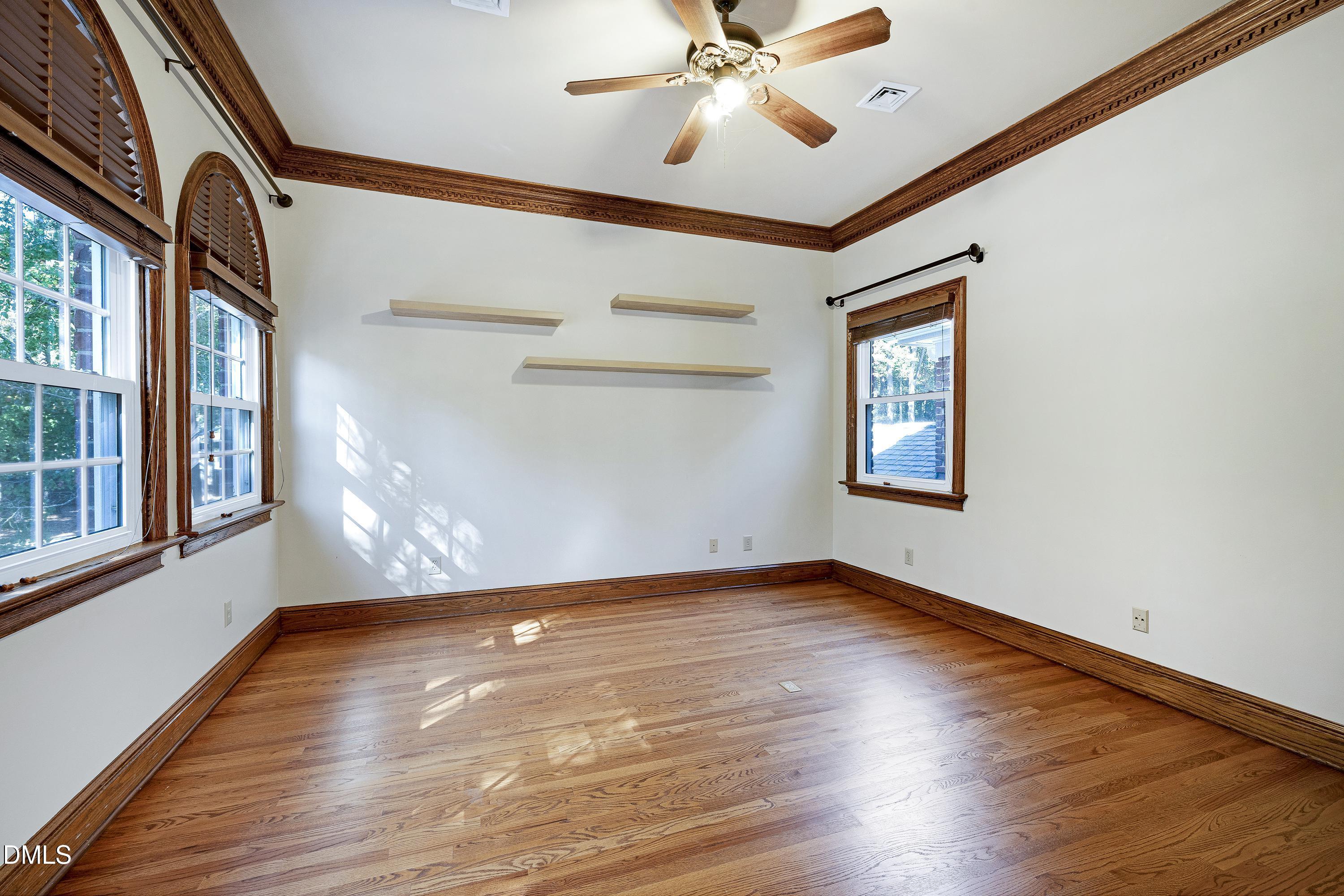 6825 Mactavish Way Raleigh, NC 27613 - Photo 43 of 100 a view of an empty room with wooden floor and a window