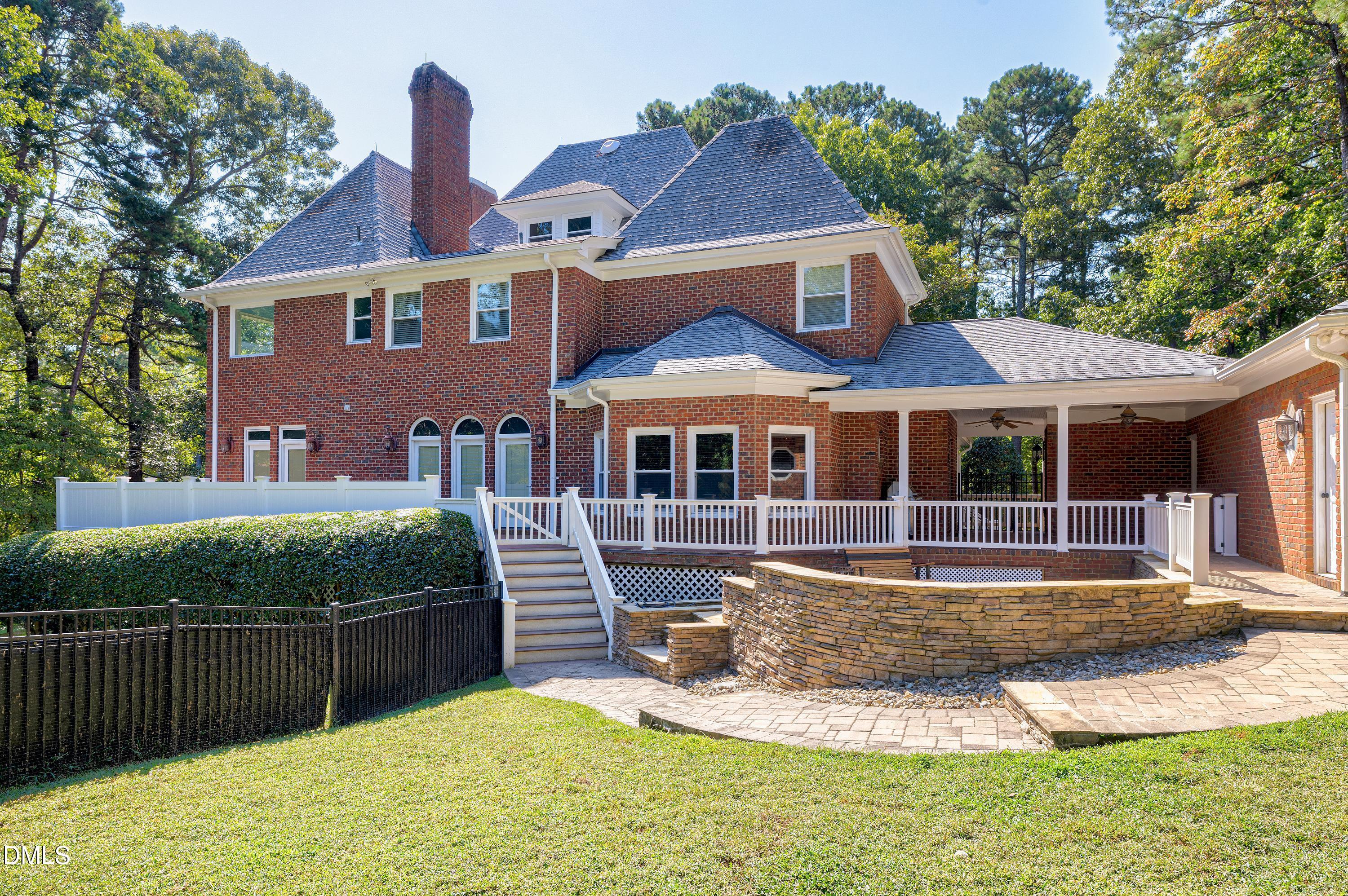 6825 Mactavish Way Raleigh, NC 27613 - Photo 60 of 100 a front view of a house with a yard table and chairs