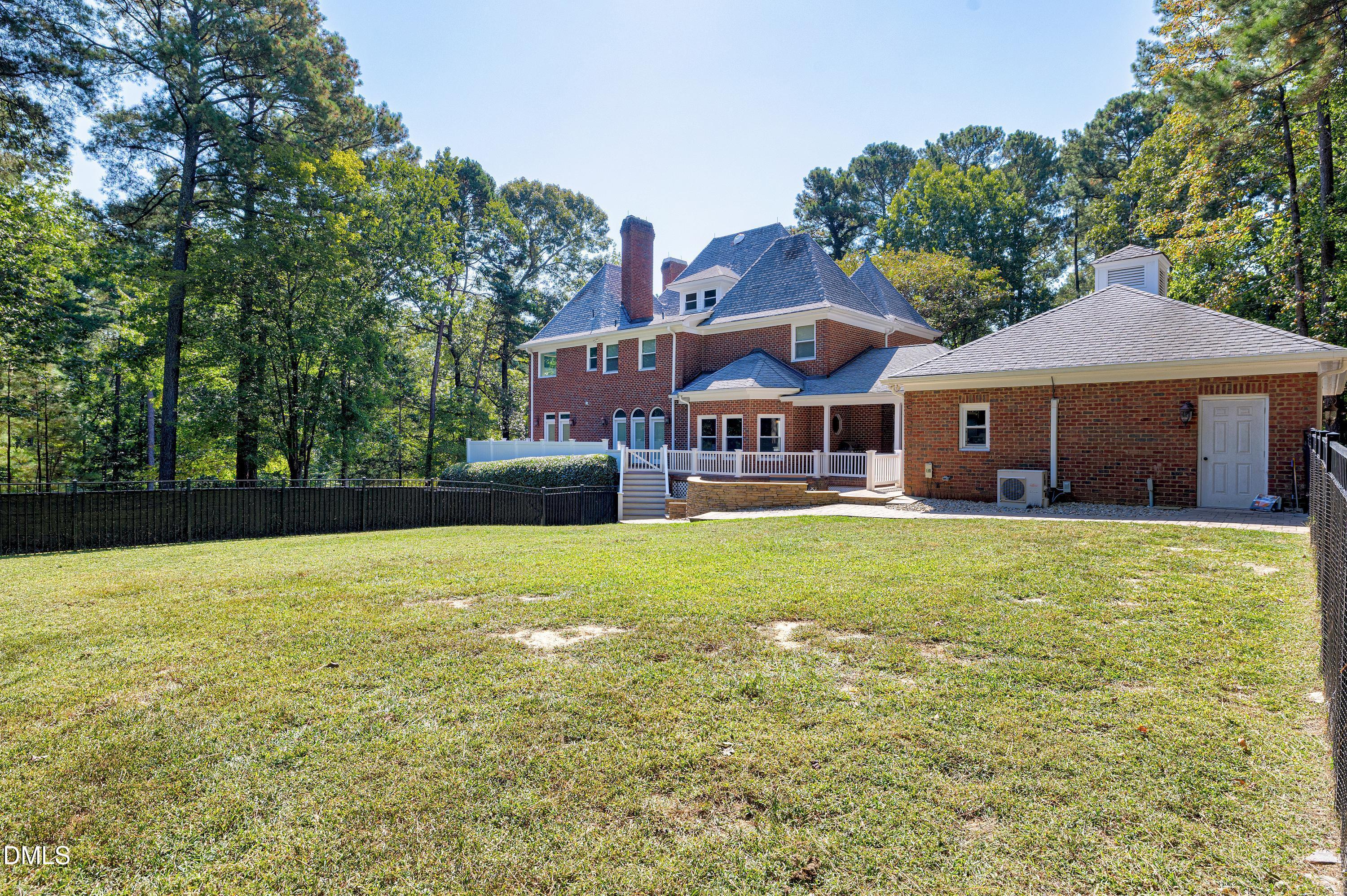 6825 Mactavish Way Raleigh, NC 27613 - Photo 73 of 100 a front view of a house with a garden