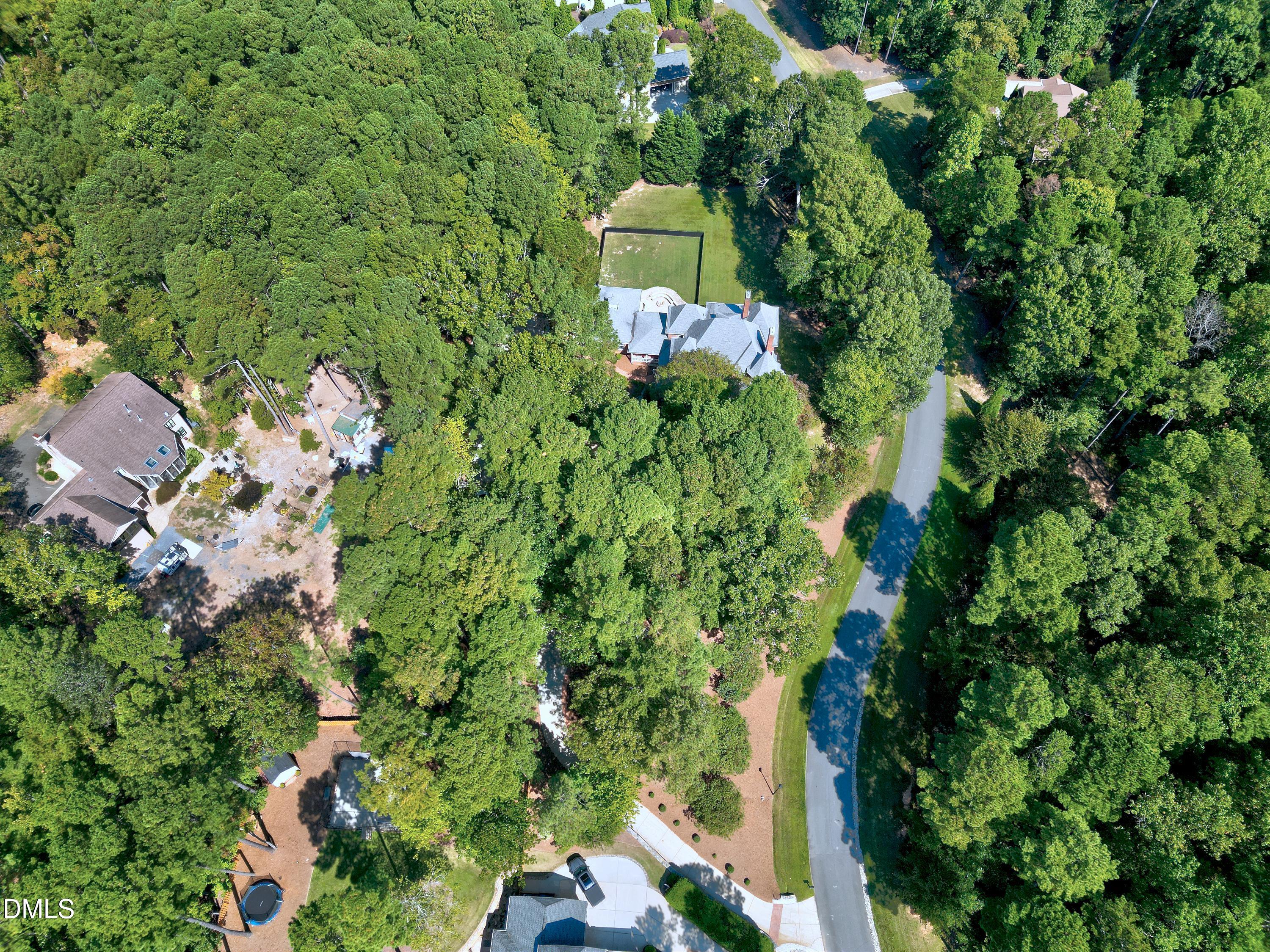 6825 Mactavish Way Raleigh, NC 27613 - Photo 97 of 100 an aerial view of a house with a yard and large trees