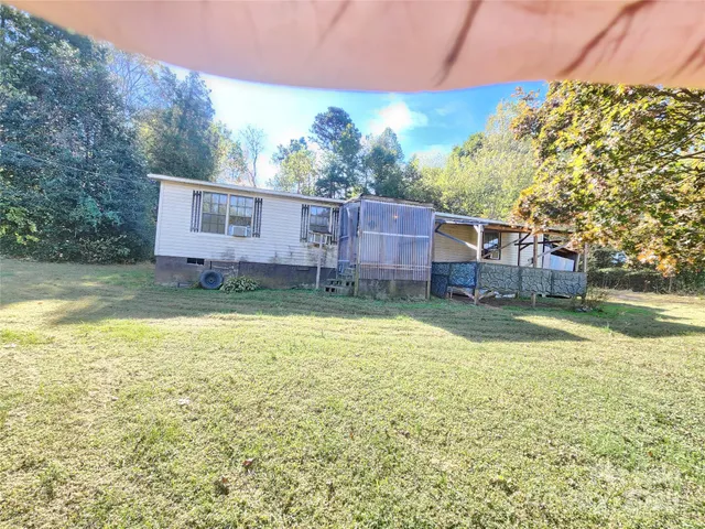 a view of a house with a yard and sitting area