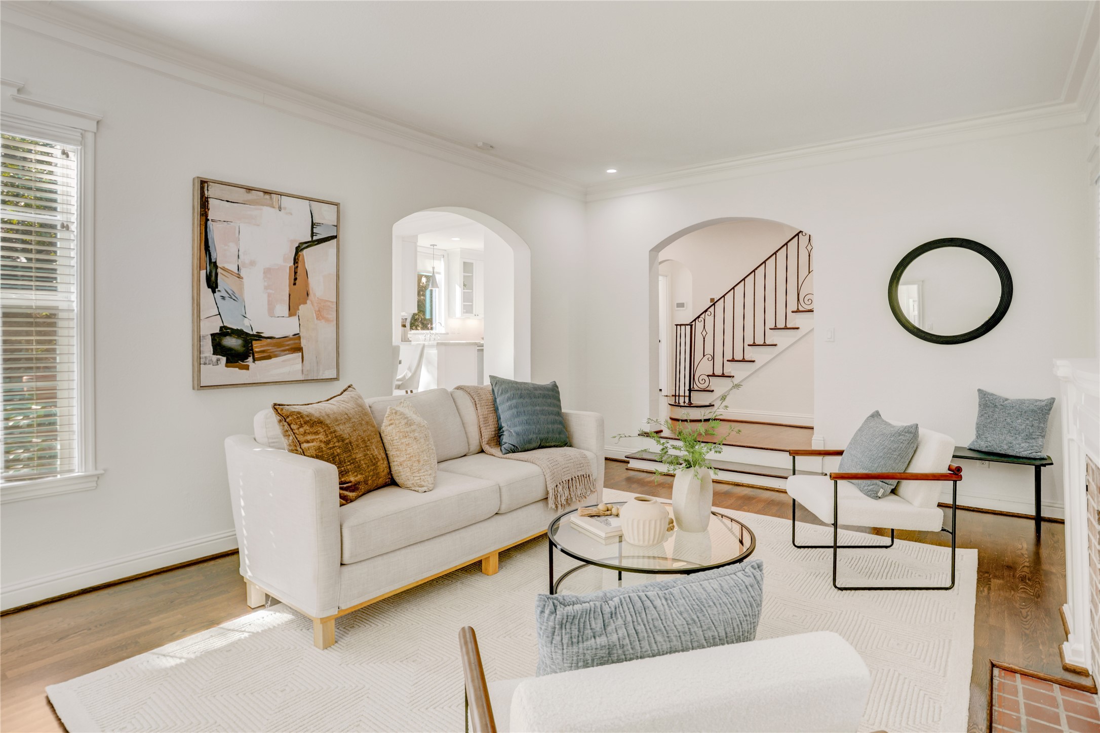 a living room with furniture a rug and a large window