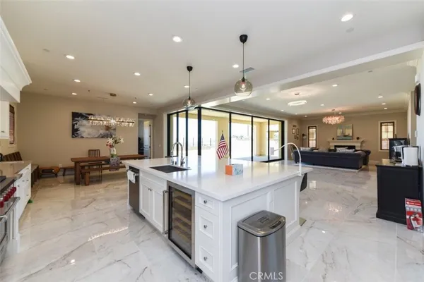 a large white kitchen with a large window