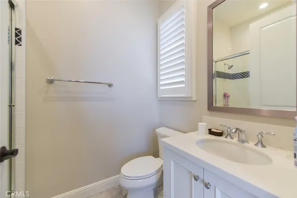 a bathroom with a sink toilet vanity and a mirror