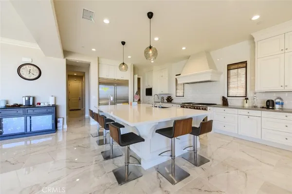 a large kitchen with a table and chairs