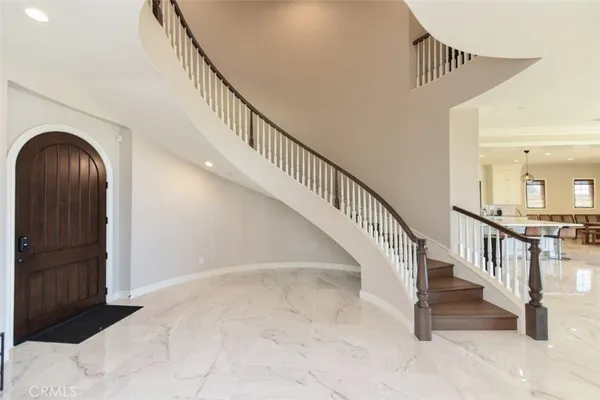 a view of staircase with white walls and a rug