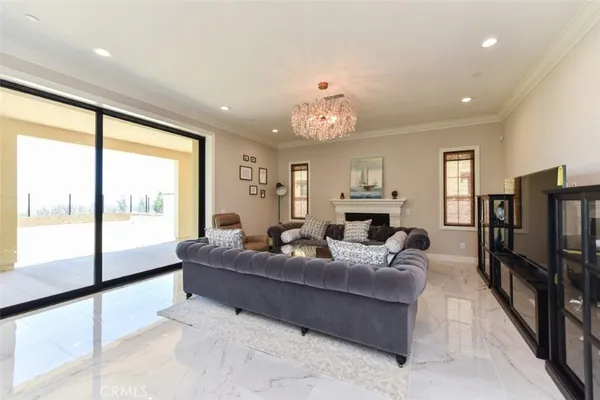 a living room with fireplace furniture and a large window