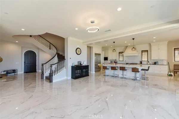 a living room with lots of furniture and a view of kitchen