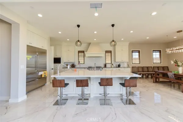a large kitchen with a table and chairs