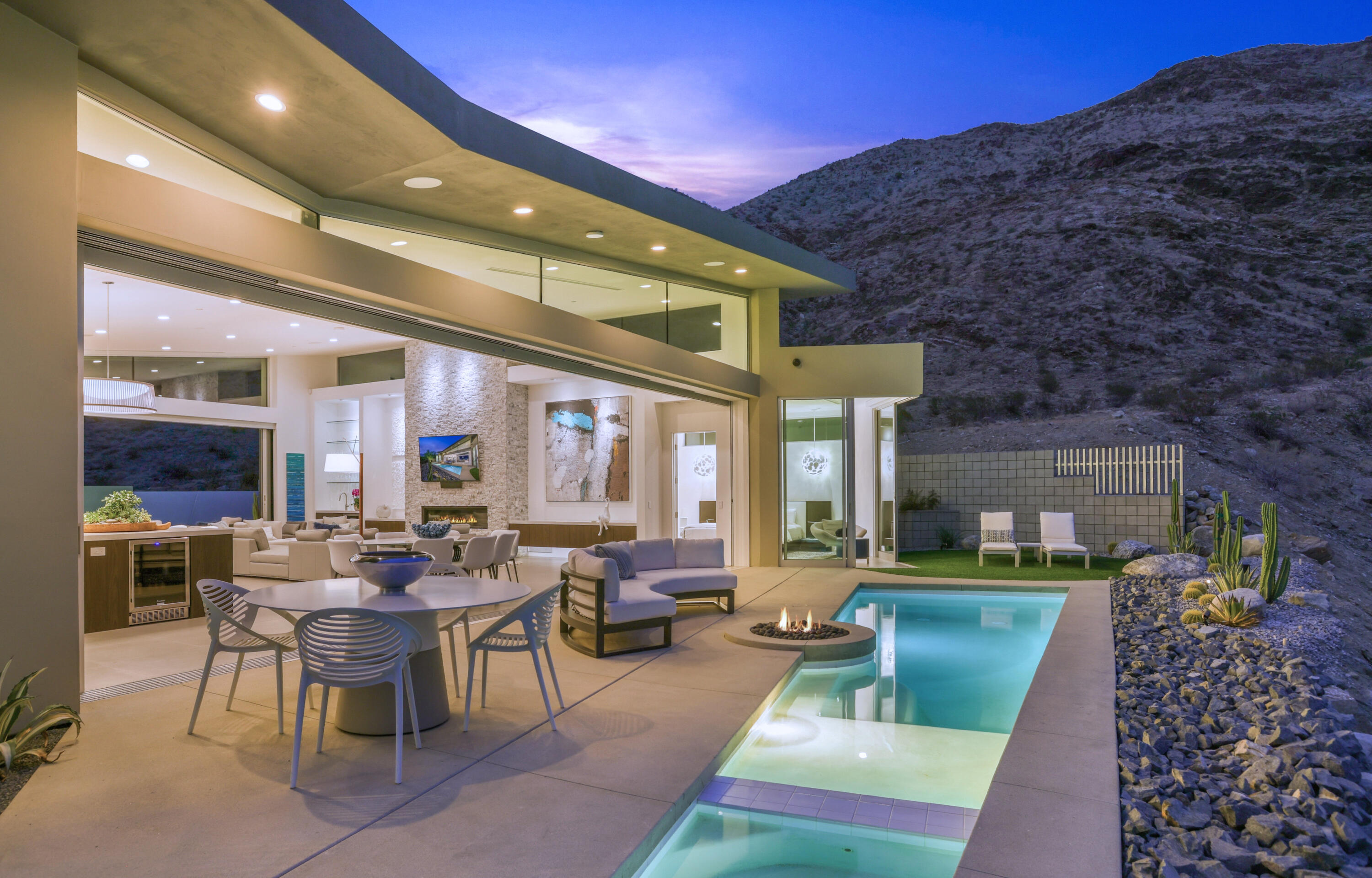 1747 Pinnacle Point Palm Springs, CA 92264 - Photo 2 of 76 a living room with furniture a rug and a fireplace