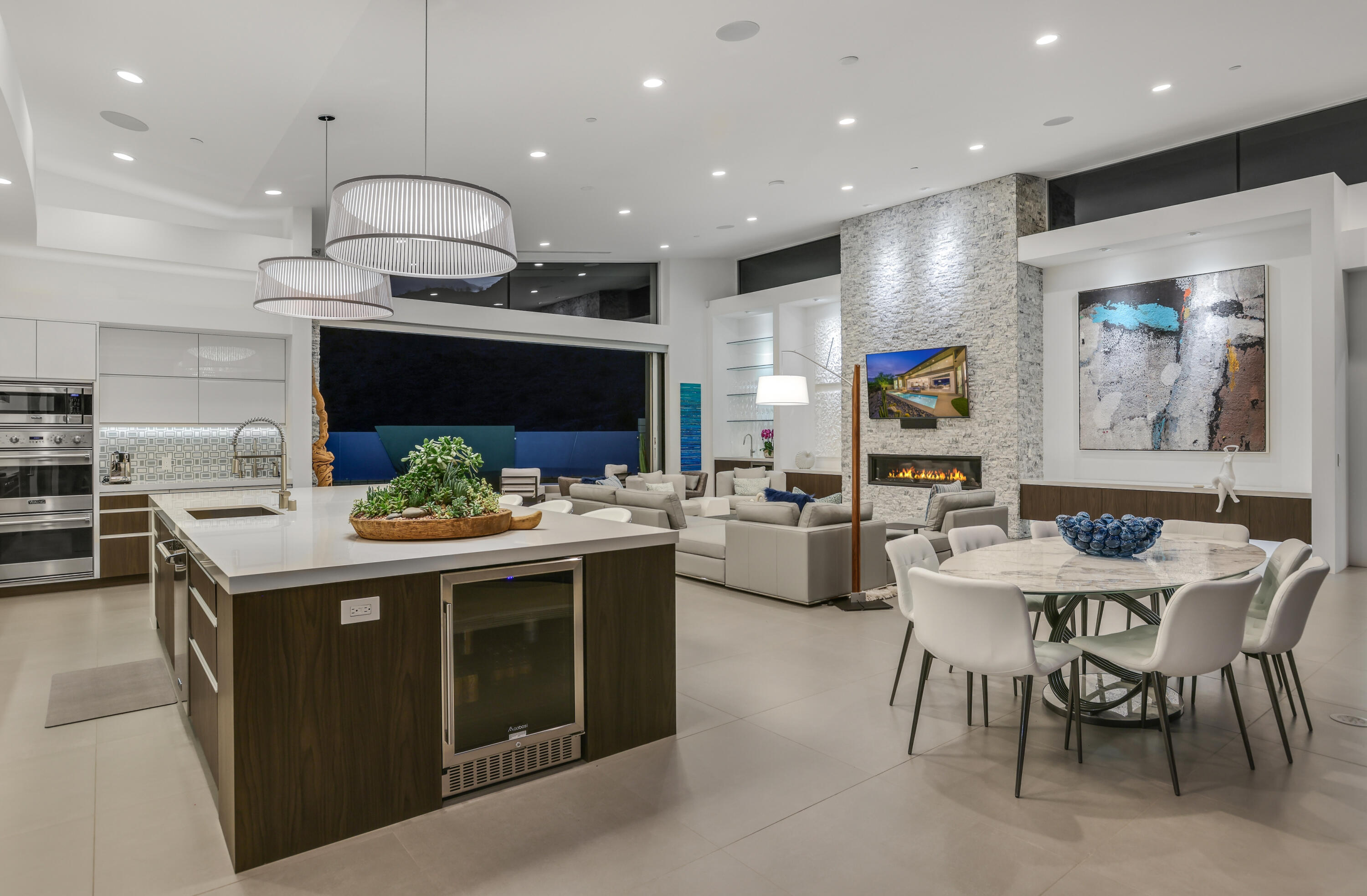 1747 Pinnacle Point Palm Springs, CA 92264 - Photo 20 of 76 a kitchen with stainless steel appliances kitchen island granite countertop a table and chairs in it