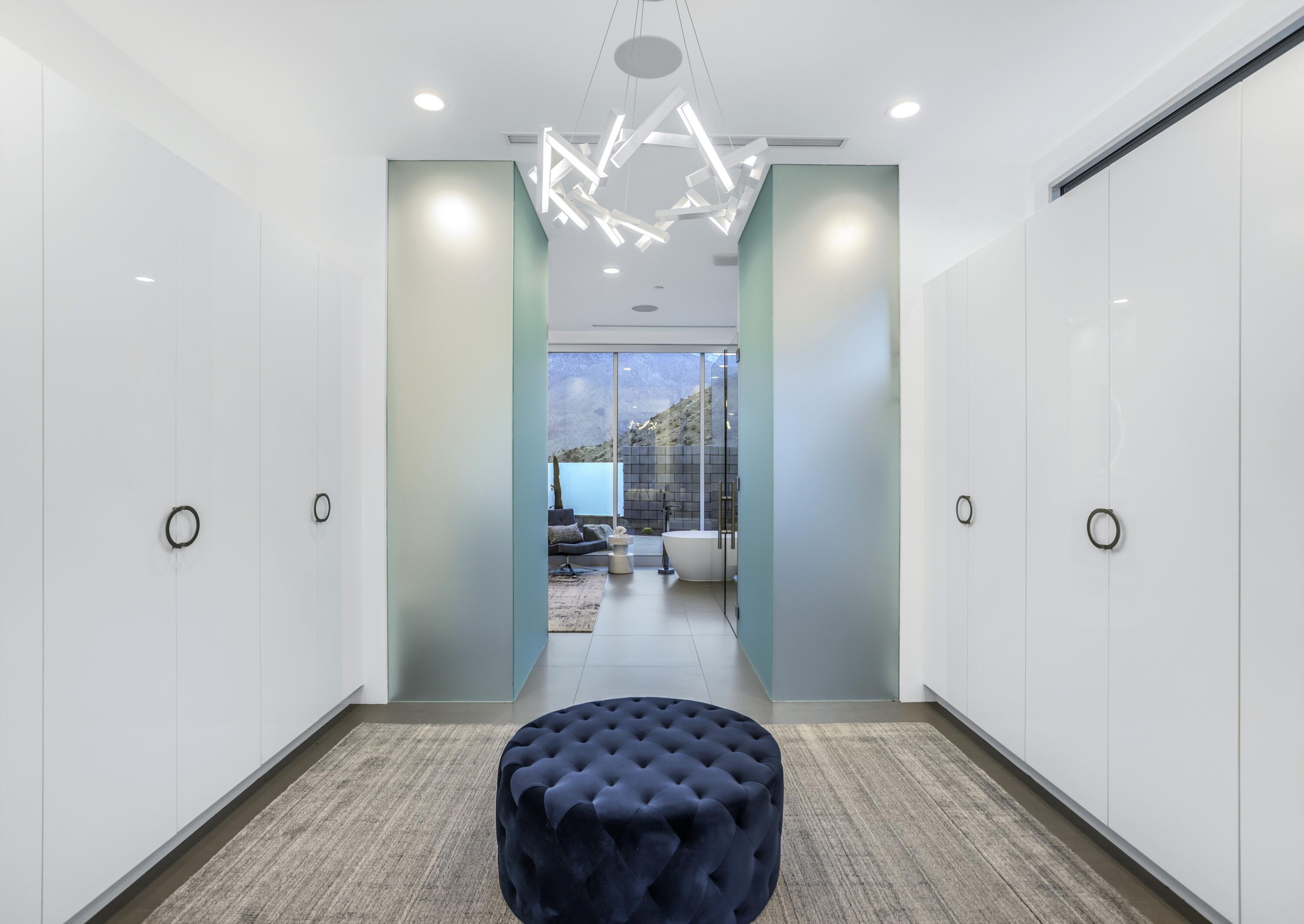 1747 Pinnacle Point Palm Springs, CA 92264 - Photo 34 of 76 a bedroom with a bed and a chandelier