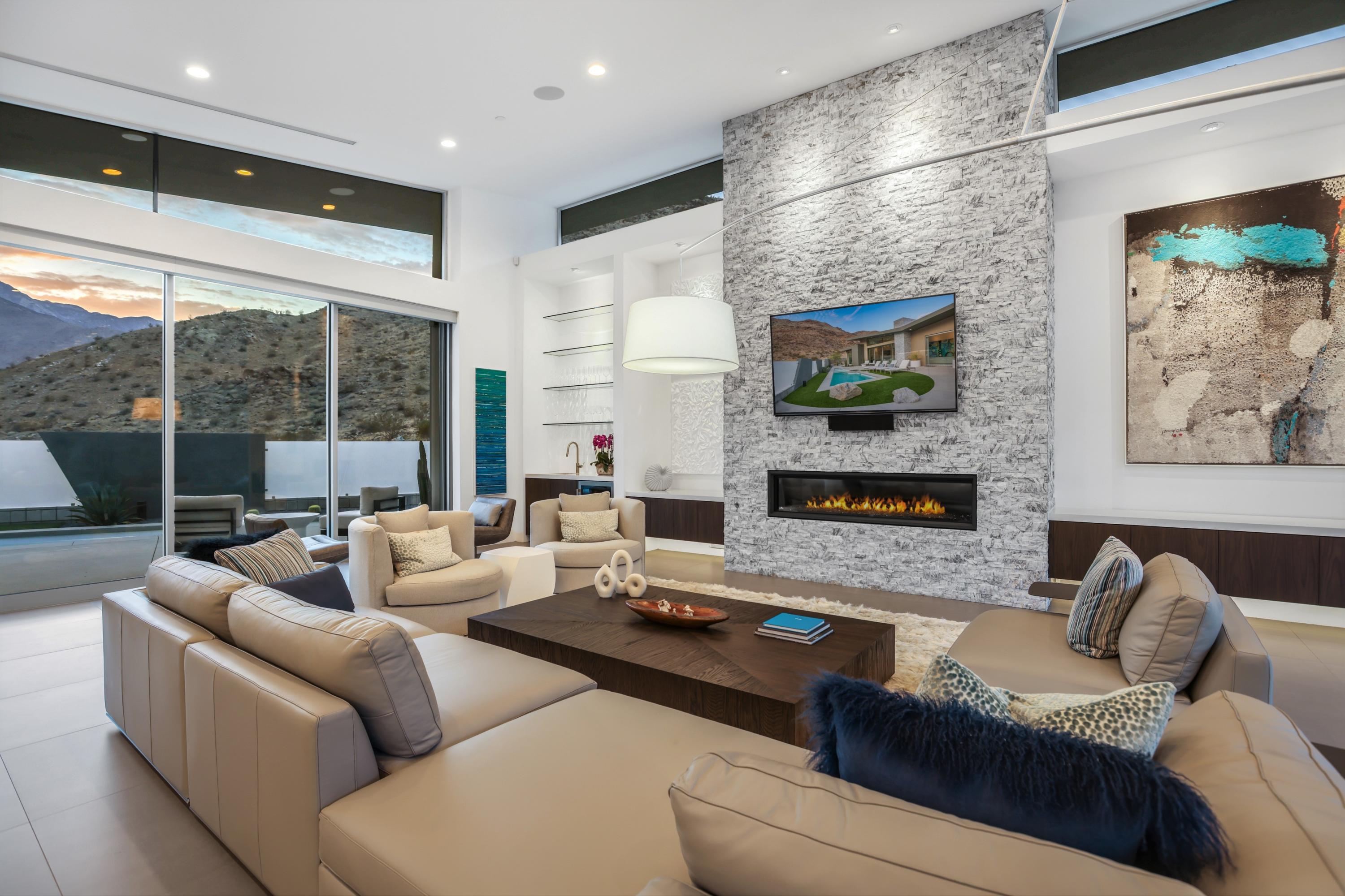 1747 Pinnacle Point Palm Springs, CA 92264 - Photo 51 of 76 a living room with furniture a fireplace and a flat screen tv