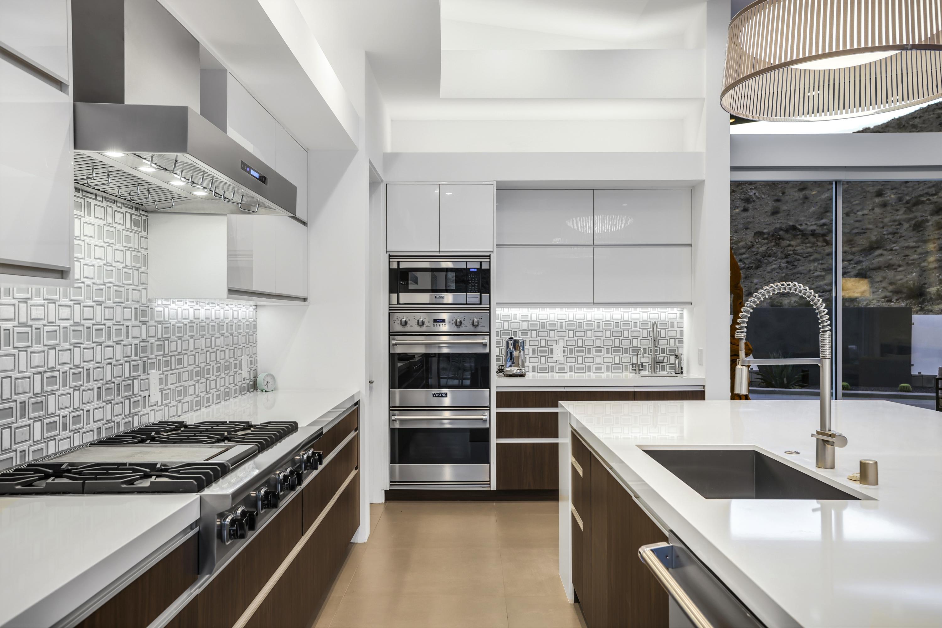 1747 Pinnacle Point Palm Springs, CA 92264 - Photo 52 of 76 a kitchen with stainless steel appliances granite countertop a sink and a stove