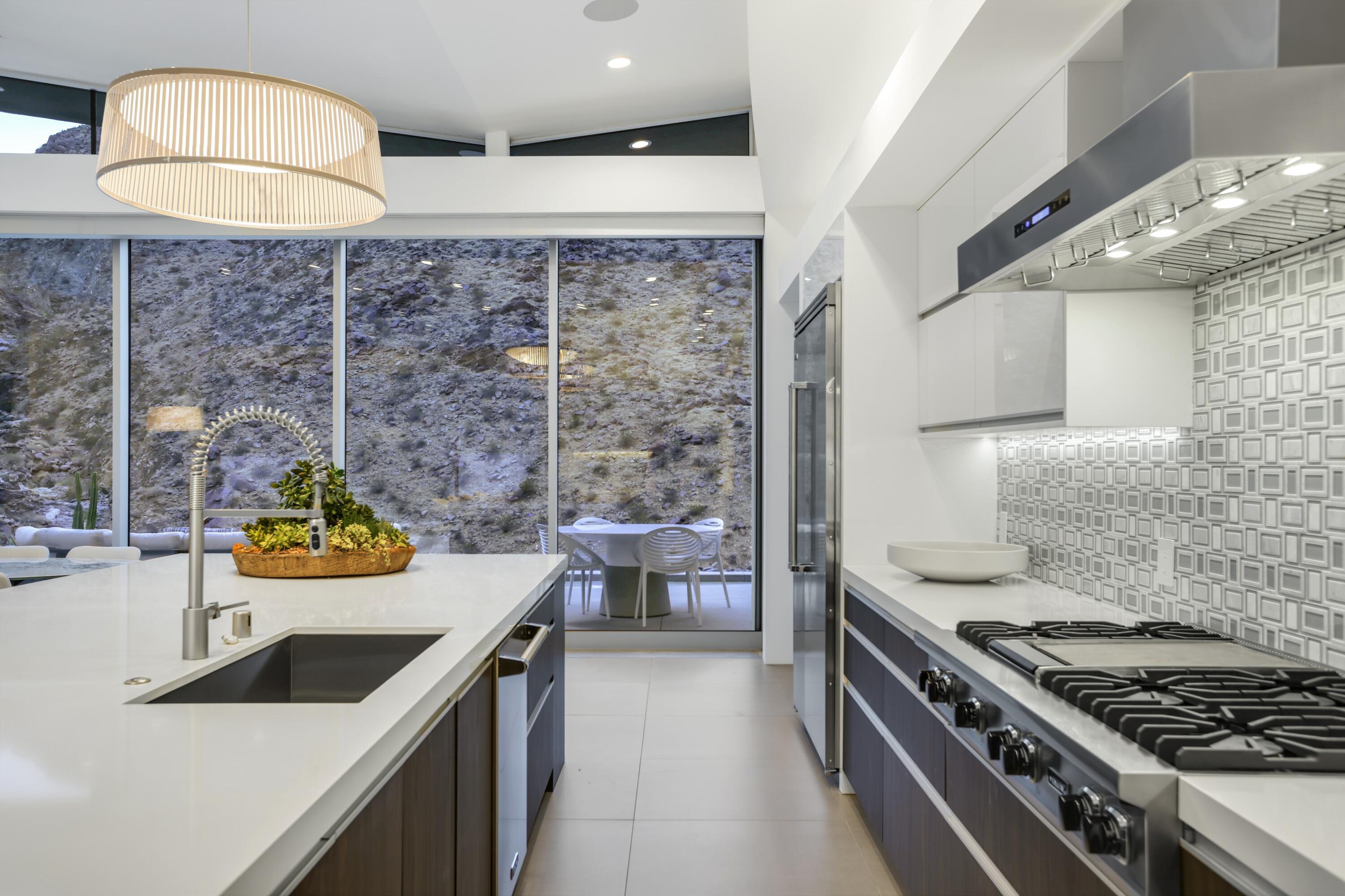 1747 Pinnacle Point Palm Springs, CA 92264 - Photo 55 of 76 a kitchen that has a lot of cabinets in it