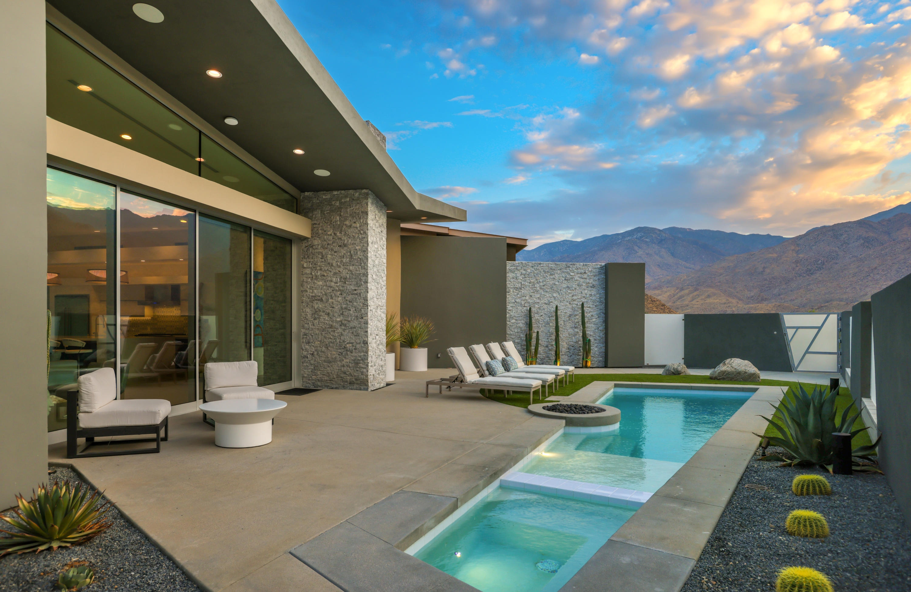 1747 Pinnacle Point Palm Springs, CA 92264 - Photo 66 of 76 a view of a patio with couches table and chairs with wooden floor and fence