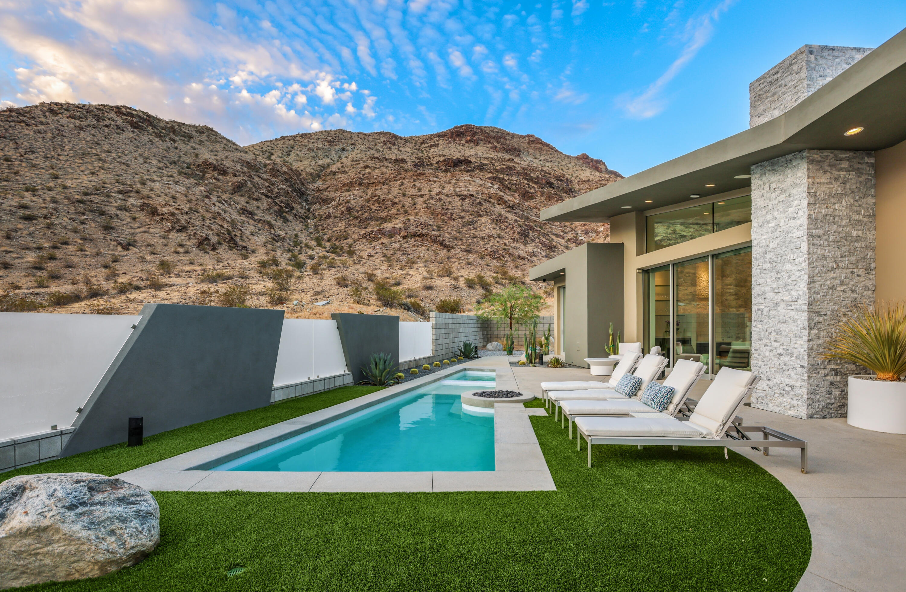 1747 Pinnacle Point Palm Springs, CA 92264 - Photo 70 of 76 a view of a patio with couches chairs under an umbrella with a yard