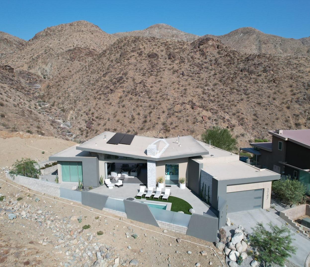1747 Pinnacle Point Palm Springs, CA 92264 - Photo 75 of 76 a front view of a house with a yard and sitting area