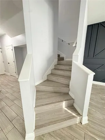 a view of a room with wooden floor and windows