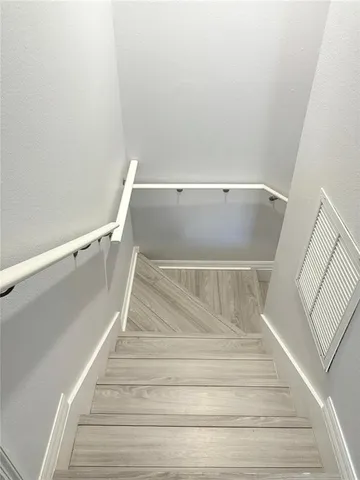 a view of a livingroom with wooden floor and a ceiling fan