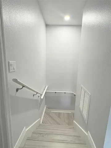 a spacious bathroom with a granite countertop sink a mirror and a shower