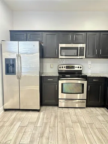 a kitchen with a stove and a refrigerator