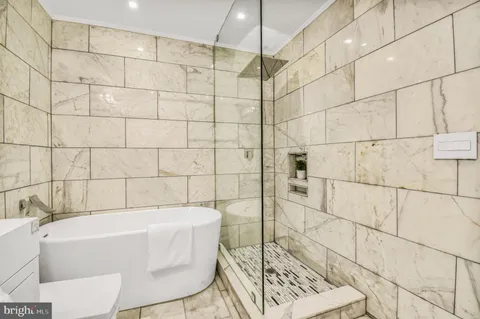 a bathroom with a white toilet a sink and bathtub