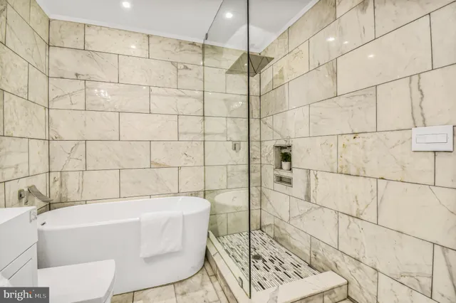 a bathroom with a white toilet a sink and bathtub