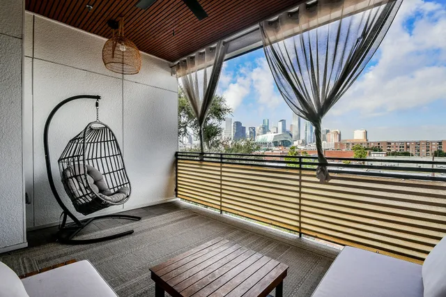 a view of a livingroom with wooden floor door and furniture