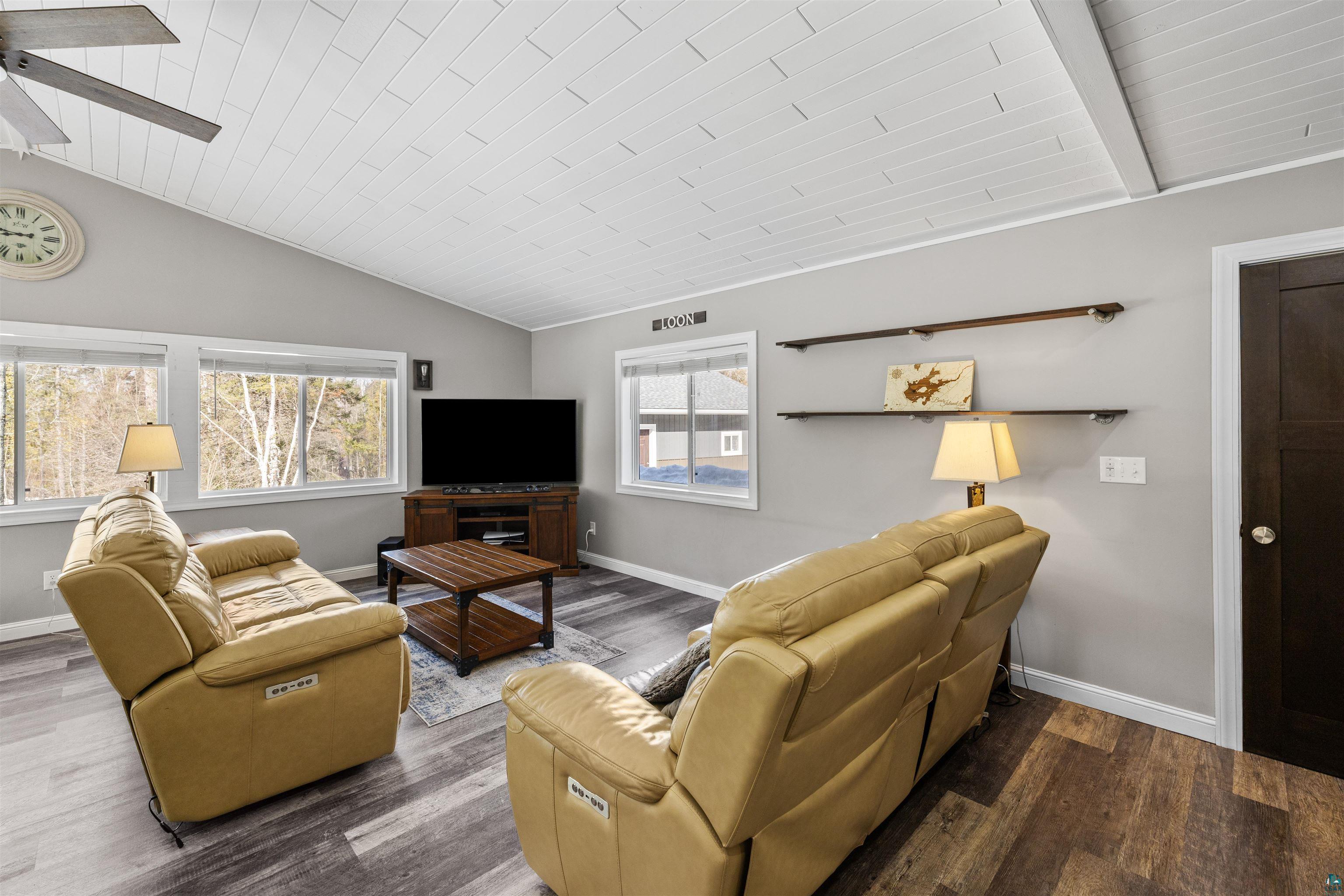 13462 Villa Road Ely, MN 55731 - Photo 14 of 68 Living area with ceiling fan, Lifeproof flooring, and a vaulted wood ceiling