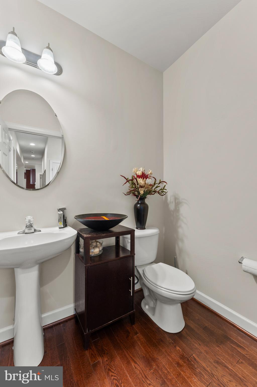 10916 Sir Paul Place Clinton, MD 20735 - Photo 19 of 66 a bathroom with a sink toilet and a mirror