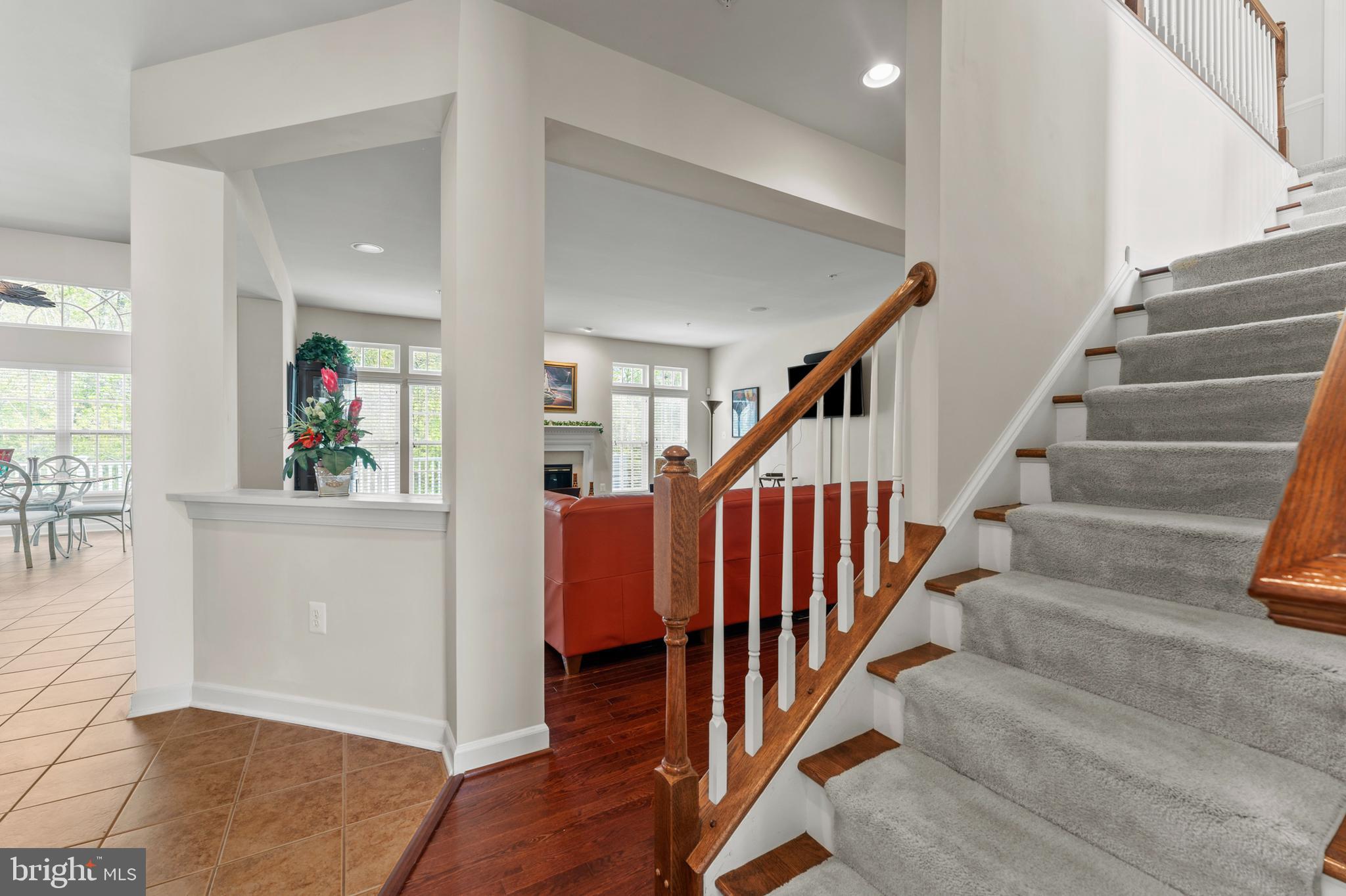 10916 Sir Paul Place Clinton, MD 20735 - Photo 25 of 66 a view of staircase with lots of frames on wall and wooden floor
