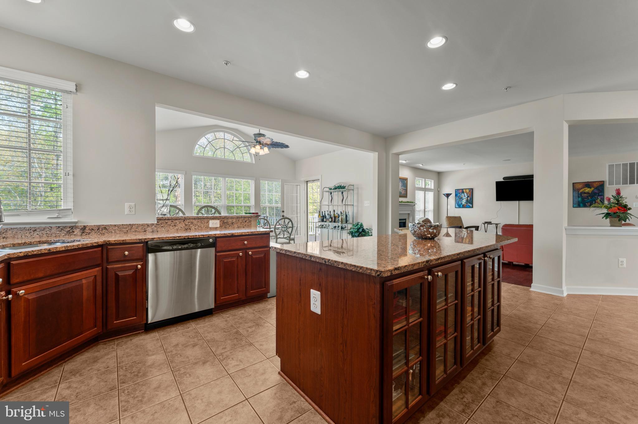 10916 Sir Paul Place Clinton, MD 20735 - Photo 30 of 66 a kitchen with stainless steel appliances granite countertop a sink and a refrigerator