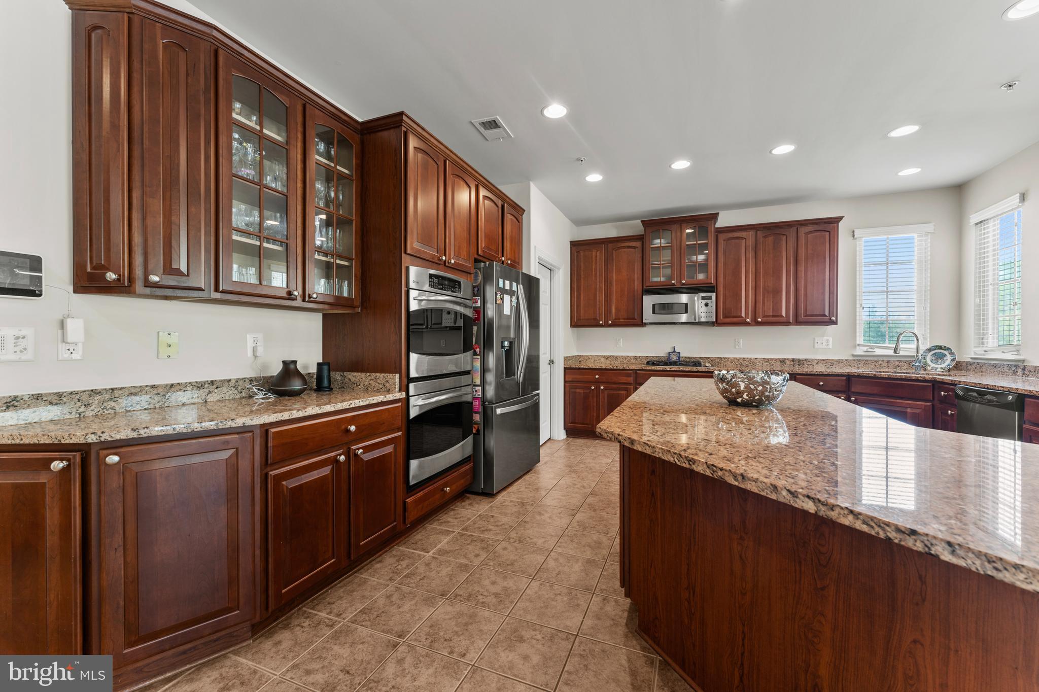 10916 Sir Paul Place Clinton, MD 20735 - Photo 31 of 66 a kitchen with stainless steel appliances granite countertop a sink stove and cabinets