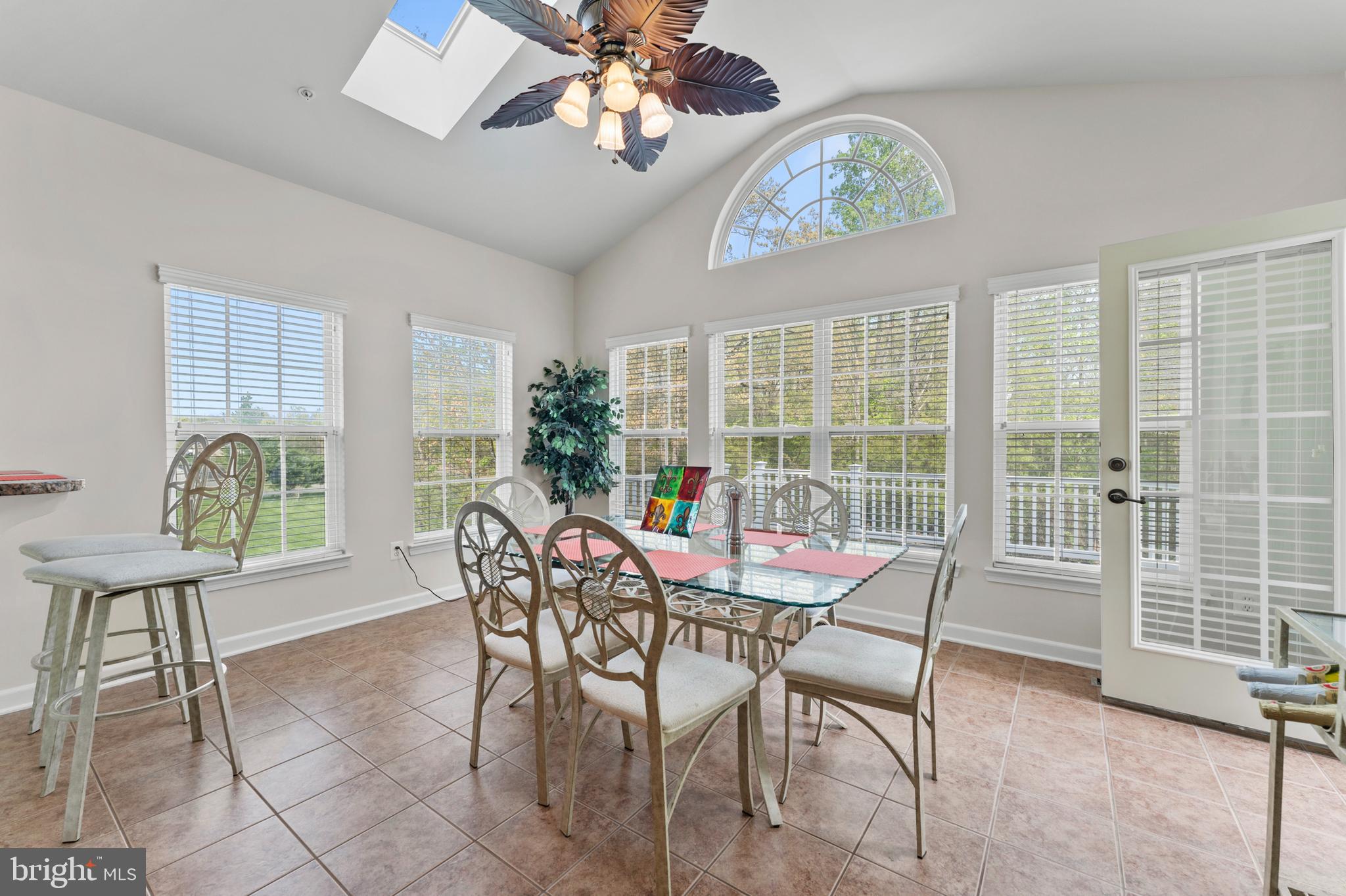 10916 Sir Paul Place Clinton, MD 20735 - Photo 32 of 66 a view of a dining room with furniture a chandelier and wooden floor