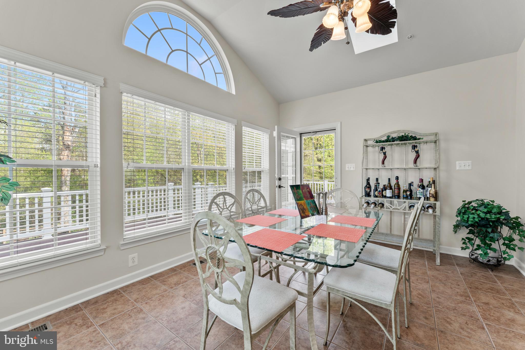 10916 Sir Paul Place Clinton, MD 20735 - Photo 33 of 66 a dining room with furniture a chandelier and a rug
