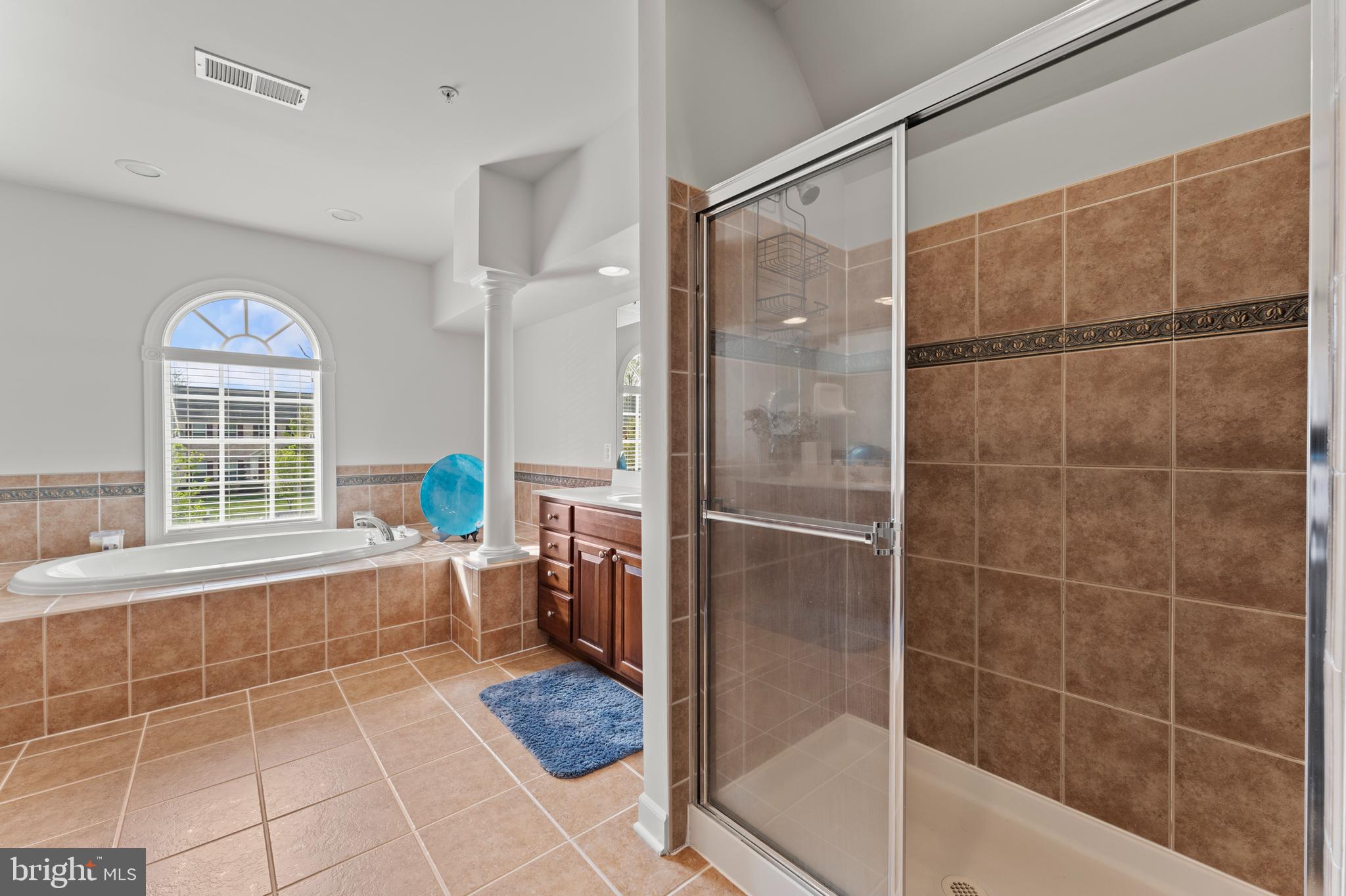 10916 Sir Paul Place Clinton, MD 20735 - Photo 43 of 66 a bathroom with a bathtub and a shower