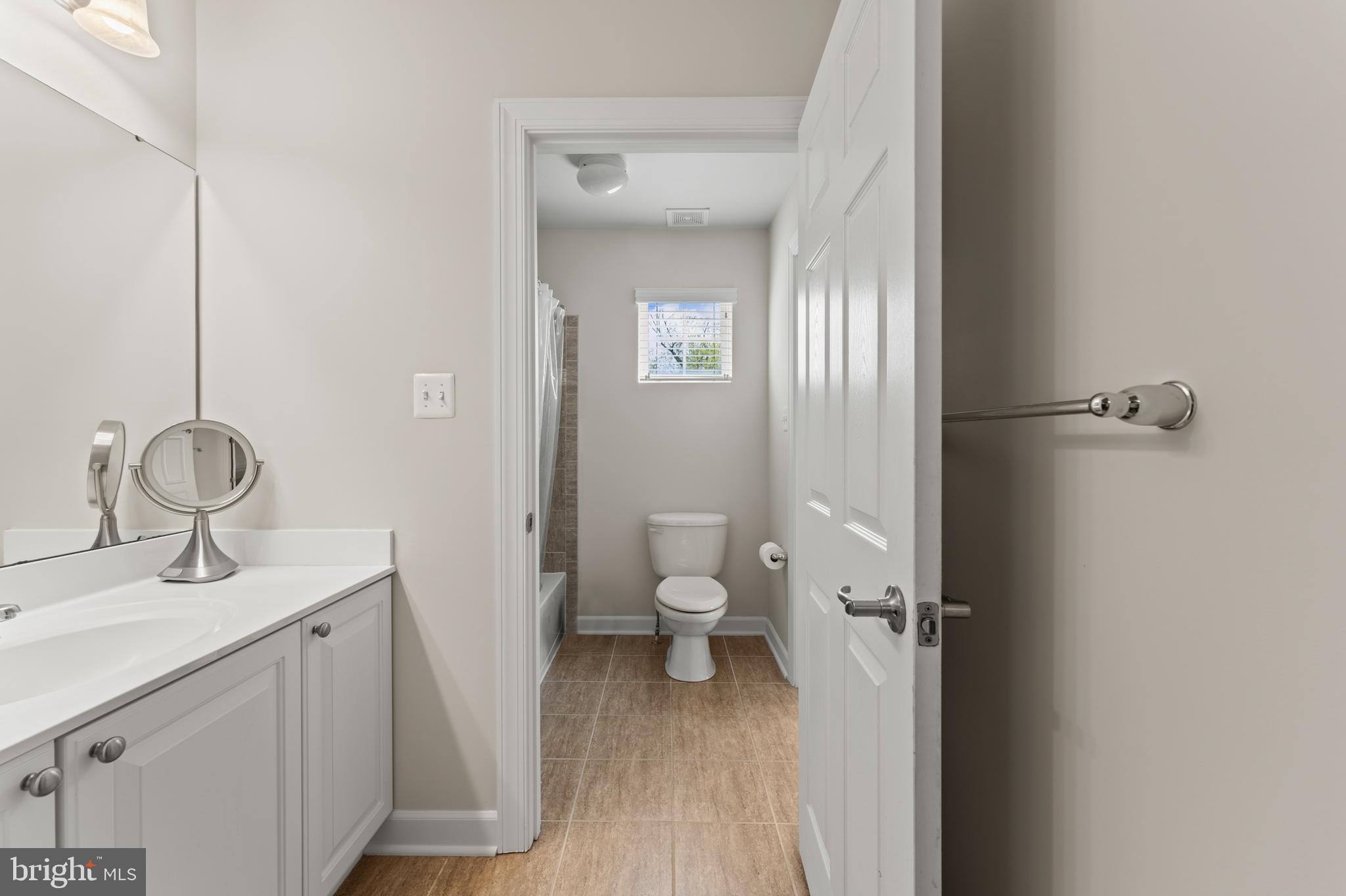10916 Sir Paul Place Clinton, MD 20735 - Photo 47 of 66 a bathroom with a toilet sink and mirror