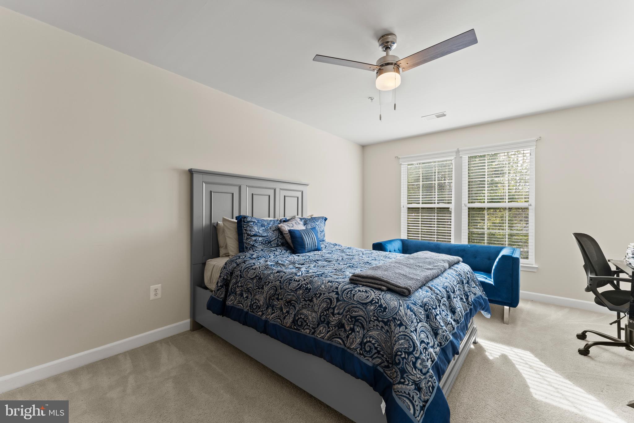10916 Sir Paul Place Clinton, MD 20735 - Photo 49 of 66 a bedroom with a bed a window and a couch