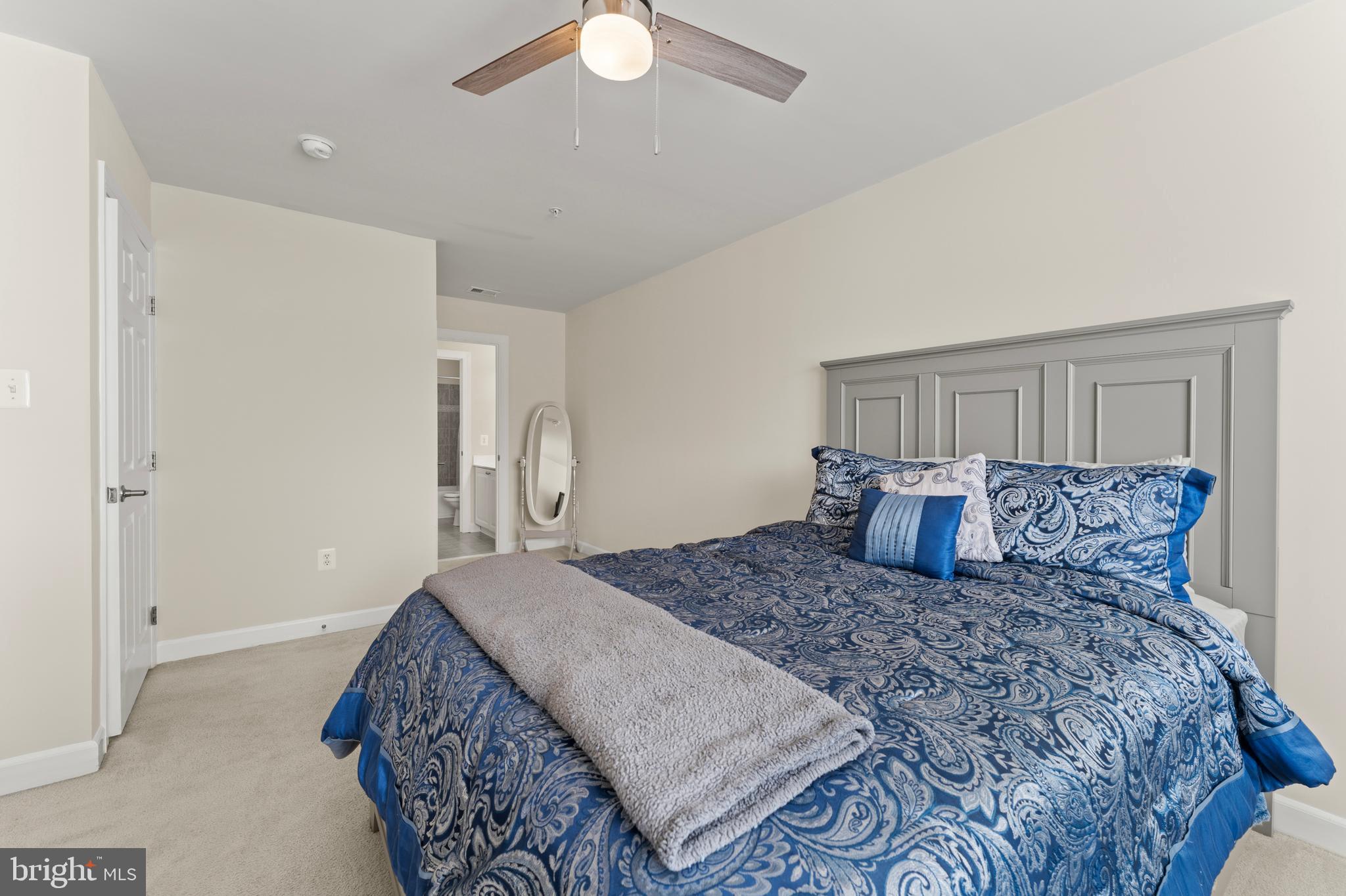10916 Sir Paul Place Clinton, MD 20735 - Photo 50 of 66 a large bedroom with a bed and a chandelier