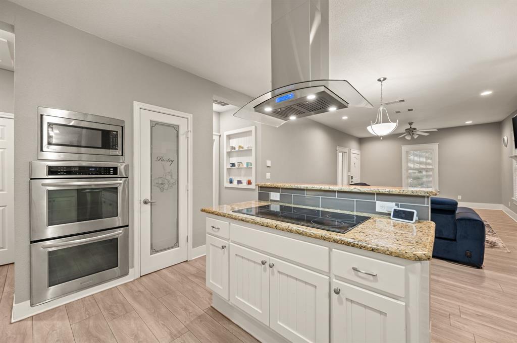 800 North Clements Street Gainesville, TX 76240 - Photo 13 of 27 a kitchen with a sink and stainless steel appliances